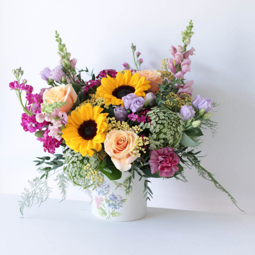 Blanco floral arrangement - featuring a mix of sunflowers, roses, snapdragons, and fragrant stock